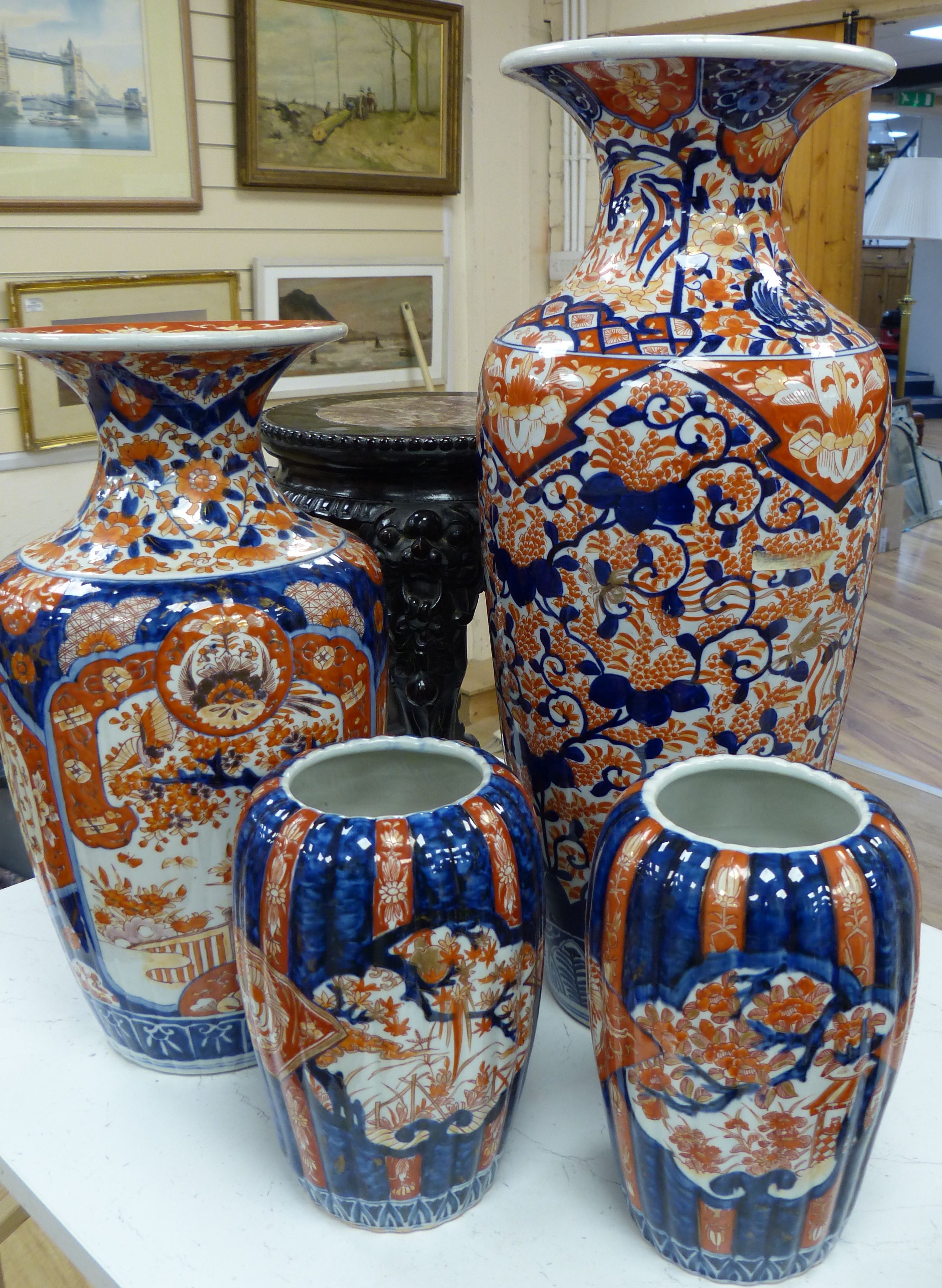 Four Japanese Imari vases, Meiji period, together with a carved hardwood and marble inset stand, tallest vase 61.5cm